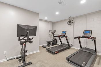 The gym in the owners suite is equipped with exercise equipment and a tv